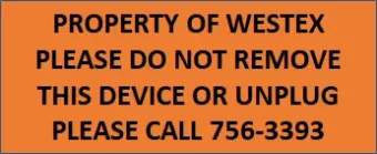 Orange label with black text that says, "Property of Wes-Tex. Please do not remove this device or unplug. Please call 756-3393."